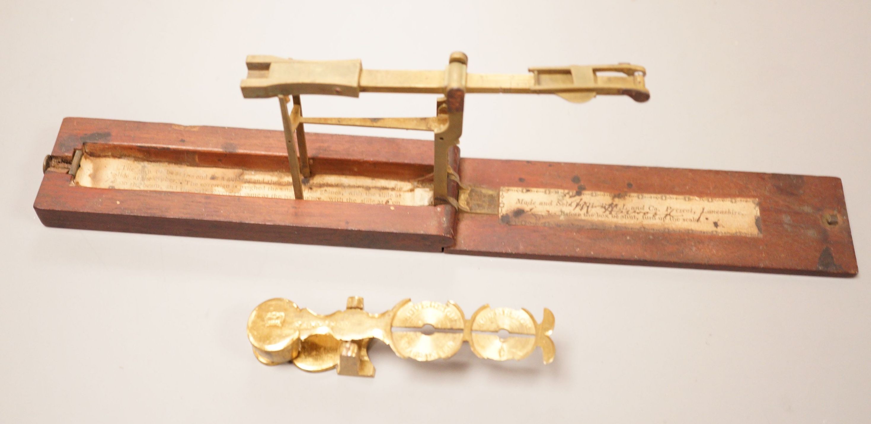 Two sets of gold / coin scales, together with a 1/2 pistol and 1 Guinea